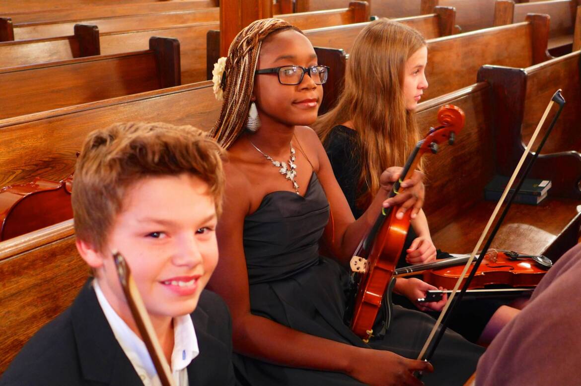 Kids-in-Pew-with-Instruments-scaled.jpg